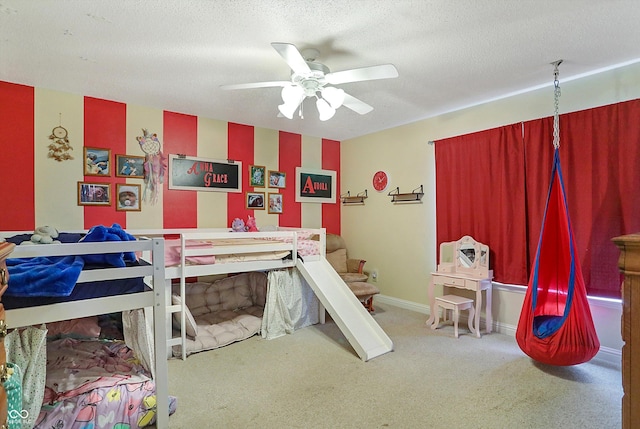 bedroom with carpet floors, a textured ceiling, and ceiling fan
