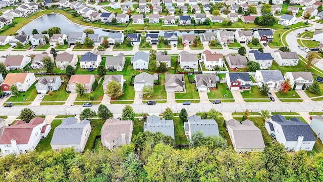 aerial view of property's location with nearby suburban area and a large body of water
