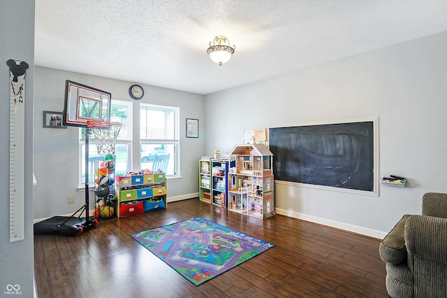 rec room featuring hardwood / wood-style flooring, baseboards, and a textured ceiling