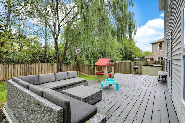 wooden terrace featuring outdoor lounge area and a fenced backyard