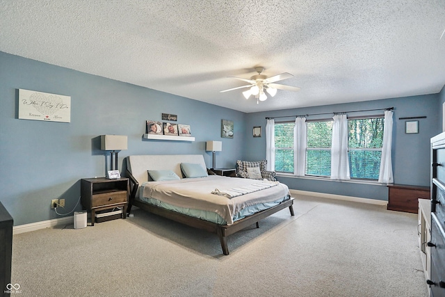 carpeted bedroom with baseboards, a textured ceiling, and a ceiling fan