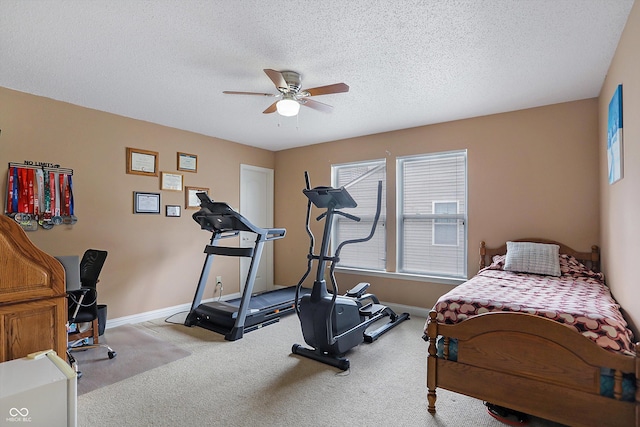 exercise area featuring a ceiling fan, plenty of natural light, a textured ceiling, and carpet floors