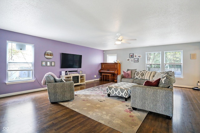 living area featuring a ceiling fan, wood finished floors, a textured ceiling, and baseboards