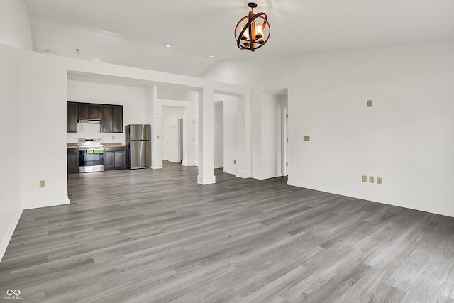 3222 Enclave Ln, Greenwood, IN 46143 - unfurnished living room with vaulted ceiling, a chandelier, wood finished floors, and baseboards