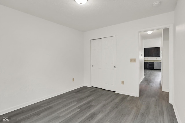 3222 Enclave Ln, Greenwood, IN 46143 - unfurnished bedroom featuring dark wood-style flooring, baseboards, and a closet
