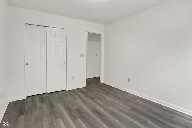3222 Enclave Ln, Greenwood, IN 46143 - unfurnished bedroom with dark wood finished floors, baseboards, and a closet