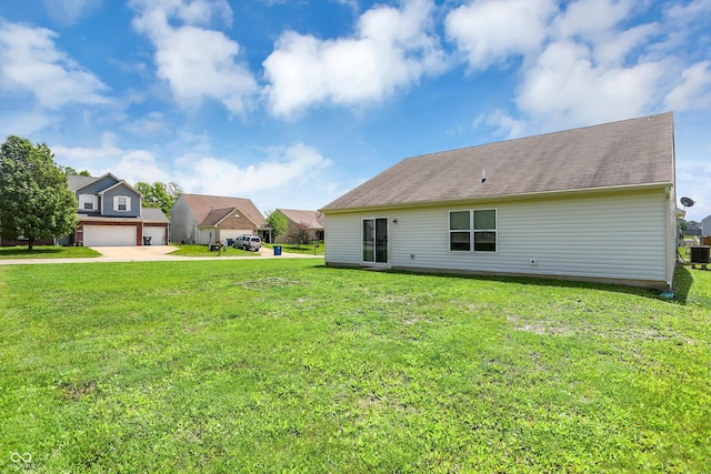 3222 Enclave Ln, Greenwood, IN 46143 - rear view of house with a lawn, concrete driveway, and central AC unit