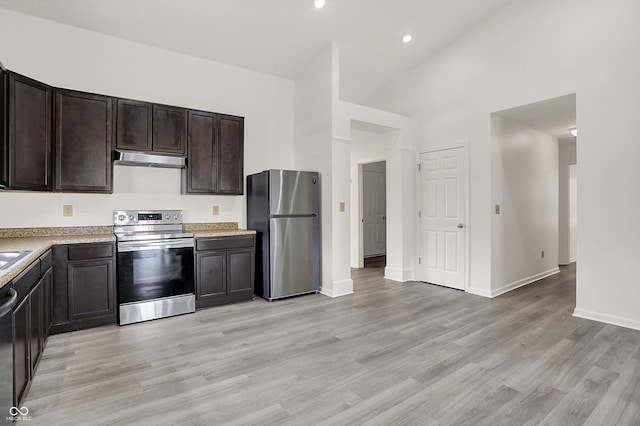 3222 Enclave Ln, Greenwood, IN 46143 - kitchen featuring stainless steel appliances, under cabinet range hood, high vaulted ceiling, light countertops, and light wood-style floors