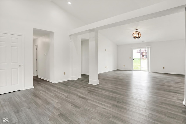 3222 Enclave Ln, Greenwood, IN 46143 - unfurnished living room with wood finished floors, lofted ceiling, baseboards, a chandelier, and recessed lighting