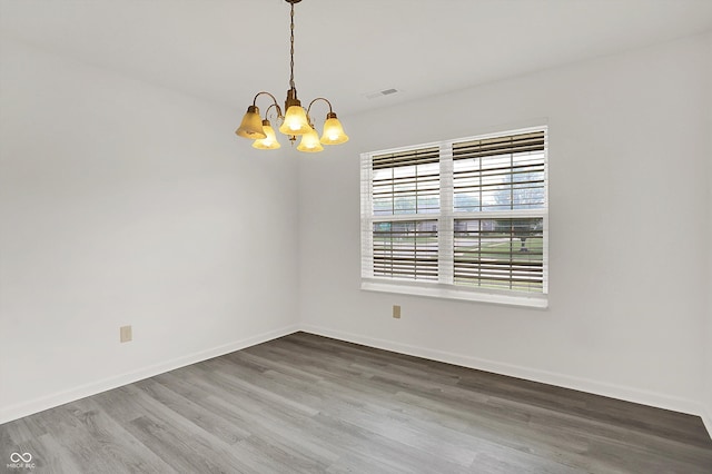 3222 Enclave Ln, Greenwood, IN 46143 - empty room featuring a chandelier, wood finished floors, and baseboards