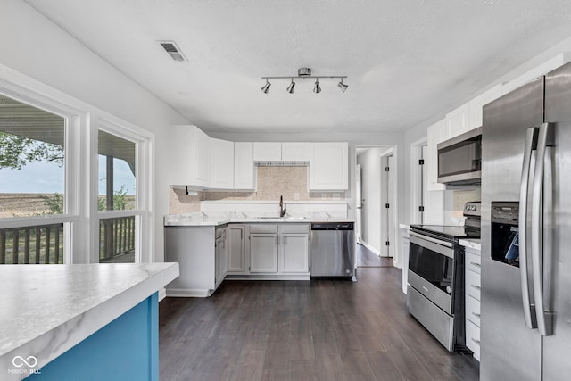 1237 W State Rd 38, Pendleton, IN 46064 - kitchen with appliances with stainless steel finishes, a sink, light countertops, dark wood-style flooring, and white cabinetry