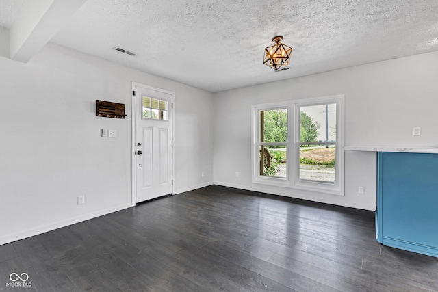 1237 W State Rd 38, Pendleton, IN 46064 - unfurnished living room with a textured ceiling, dark wood-style floors, and baseboards