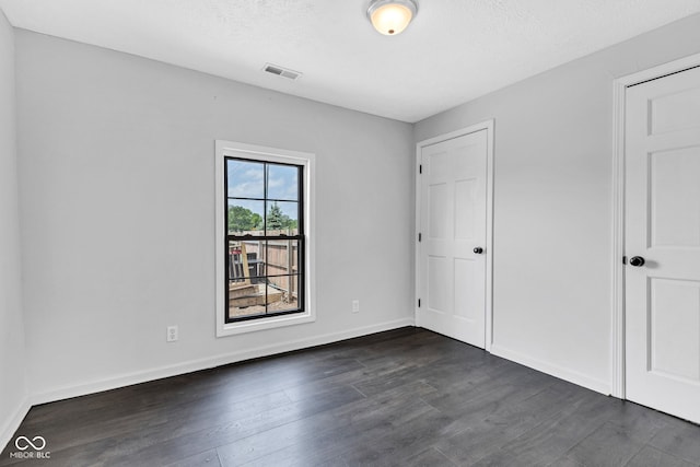 1237 W State Rd 38, Pendleton, IN 46064 - unfurnished bedroom featuring dark wood-style floors, baseboards, and a textured ceiling