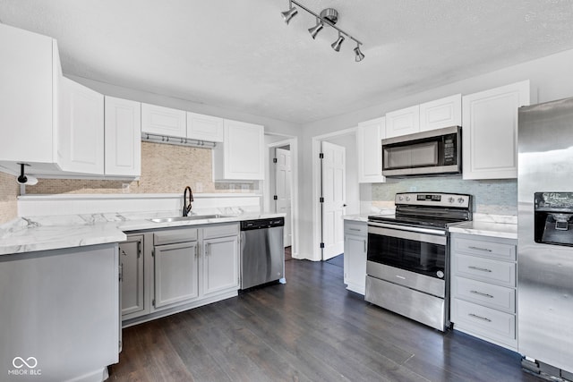 1237 W State Rd 38, Pendleton, IN 46064 - kitchen with appliances with stainless steel finishes, a sink, dark wood-style flooring, decorative backsplash, and light stone countertops