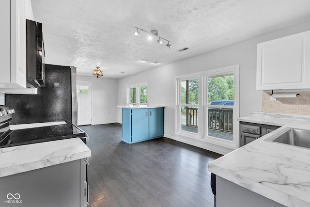 1237 W State Rd 38, Pendleton, IN 46064 - kitchen featuring decorative backsplash, freestanding refrigerator, dark wood finished floors, a textured ceiling, and white cabinets
