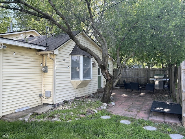 404 Pearl St, Pendleton, IN 46064 - view of side of property with a patio, fence, and roof with shingles