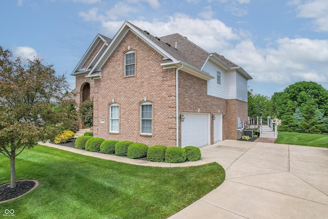 4368 W Eagle Trce, New Palestine, IN 46163 - view of side of property with driveway, a garage, brick siding, a yard, and central AC
