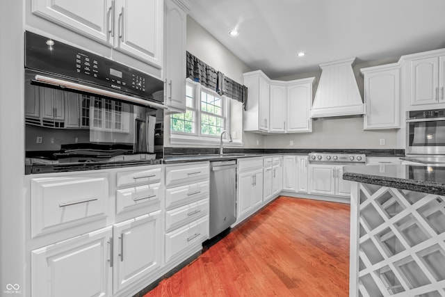 4368 W Eagle Trce, New Palestine, IN 46163 - kitchen featuring stainless steel appliances, premium range hood, a sink, white cabinetry, and recessed lighting
