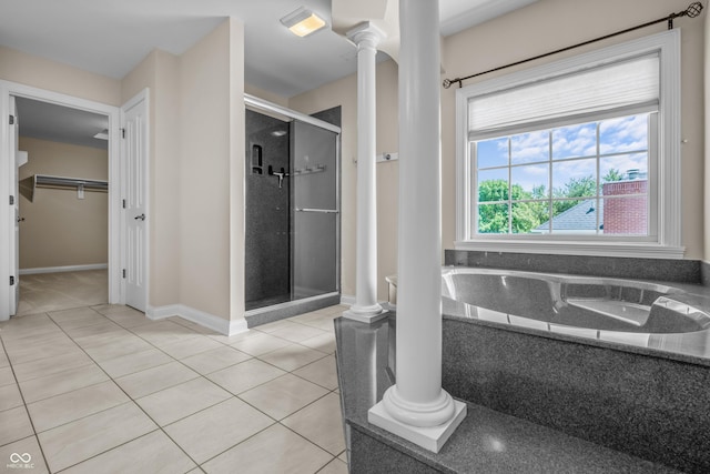 4368 W Eagle Trce, New Palestine, IN 46163 - full bath with ornate columns, a shower stall, tile patterned flooring, a walk in closet, and a bath