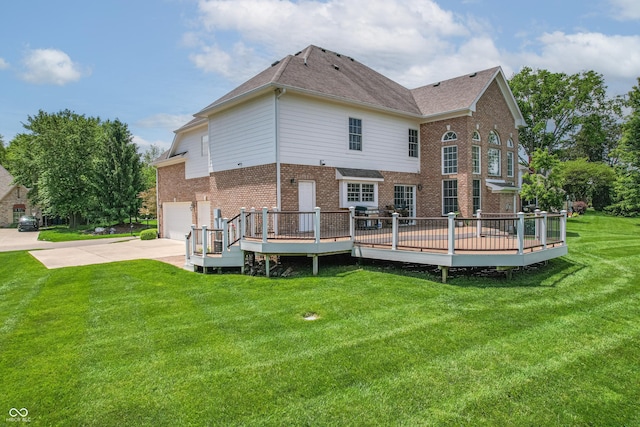 4368 W Eagle Trce, New Palestine, IN 46163 - back of property featuring concrete driveway, brick siding, a wooden deck, a yard, and a garage