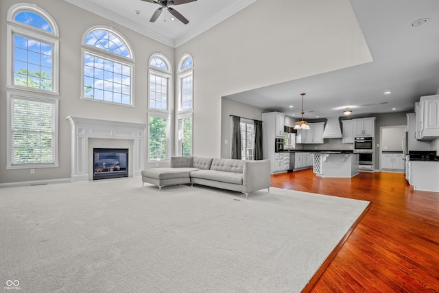 4368 W Eagle Trce, New Palestine, IN 46163 - living area featuring plenty of natural light, a ceiling fan, crown molding, wood finished floors, and recessed lighting