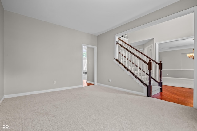 4368 W Eagle Trce, New Palestine, IN 46163 - unfurnished room with carpet flooring, a chandelier, stairway, and baseboards
