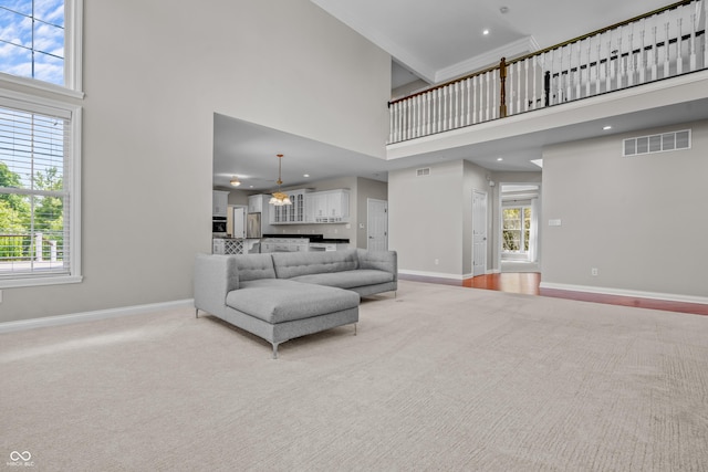 4368 W Eagle Trce, New Palestine, IN 46163 - living room featuring a high ceiling, baseboards, light carpet, plenty of natural light, and recessed lighting