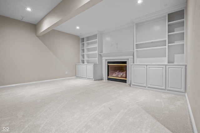 4368 W Eagle Trce, New Palestine, IN 46163 - unfurnished living room with light colored carpet, baseboards, a fireplace with flush hearth, recessed lighting, and built in shelves