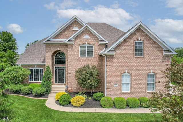 4368 W Eagle Trce, New Palestine, IN 46163 - view of front of home with brick siding, a front lawn, and a shingled roof