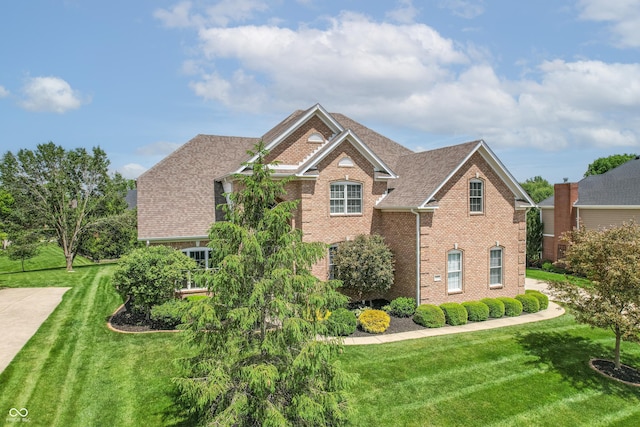 4368 W Eagle Trce, New Palestine, IN 46163 - view of front facade featuring brick siding, a front lawn, central air condition unit, and a shingled roof