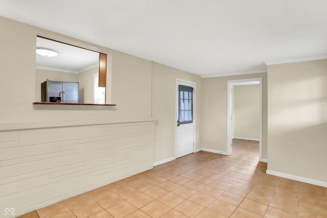 425 Aiken St, Hope, IN 47246 - entryway featuring light tile patterned flooring, ornamental molding, and plenty of natural light