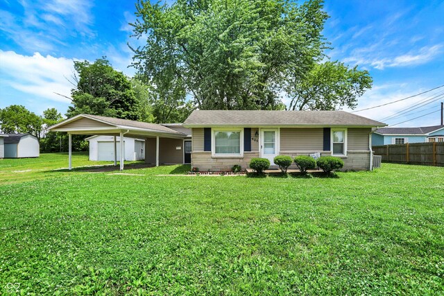 425 Aiken St, Hope, IN 47246 - single story home featuring a carport, an outdoor structure, a garage, and a shingled roof