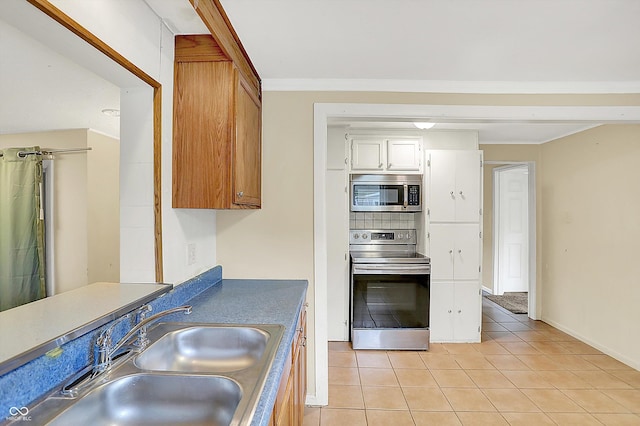 425 Aiken St, Hope, IN 47246 - kitchen featuring stainless steel appliances, light tile patterned floors, white cabinetry, and dark countertops