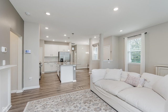 6465 Wasco Dr, Whitestown, IN 46075 - living area with light wood-style flooring, recessed lighting, and baseboards
