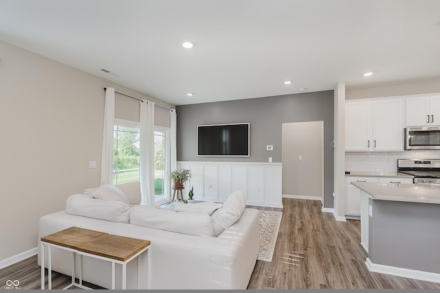 6465 Wasco Dr, Whitestown, IN 46075 - living area with light wood-type flooring, recessed lighting, and wainscoting