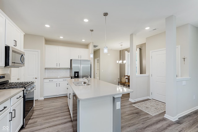 6465 Wasco Dr, Whitestown, IN 46075 - kitchen featuring appliances with stainless steel finishes, a sink, light wood-type flooring, light countertops, and decorative backsplash
