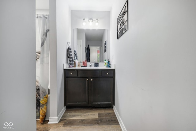 508 Jefferson, Coatesville, IN 46121 - bathroom with wood finished floors, vanity, and baseboards