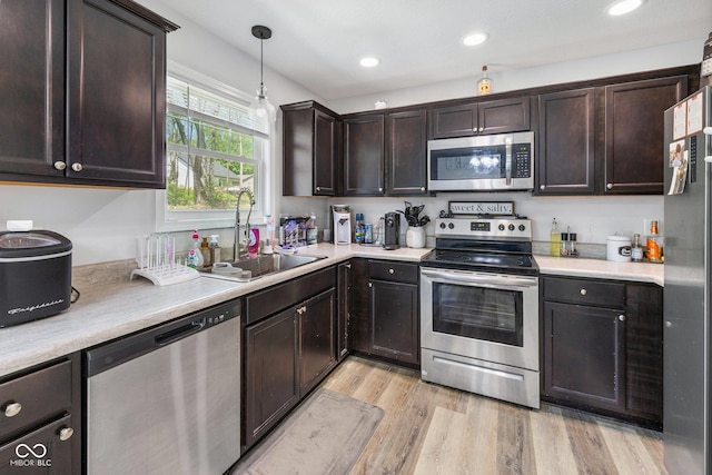 508 Jefferson, Coatesville, IN 46121 - kitchen with appliances with stainless steel finishes, a sink, dark brown cabinets, light wood finished floors, and recessed lighting