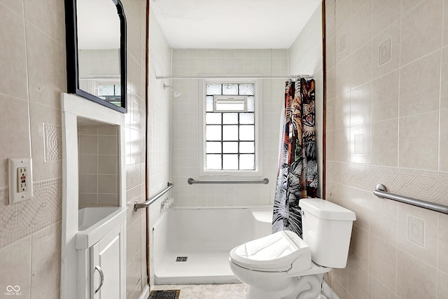 1523 E Mills Ave, Indianapolis, IN 46227 - bathroom with tile walls, a shower with shower curtain, and toilet