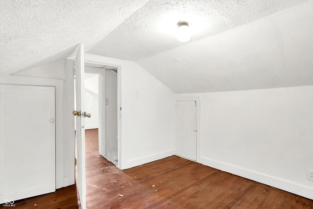 1523 E Mills Ave, Indianapolis, IN 46227 - additional living space with a textured ceiling, hardwood / wood-style floors, vaulted ceiling, and baseboards