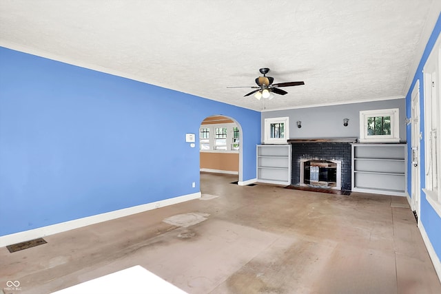 1523 E Mills Ave, Indianapolis, IN 46227 - unfurnished living room with baseboards, arched walkways, a fireplace, ceiling fan, and a textured ceiling