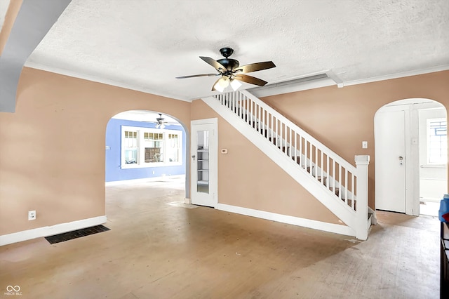 1523 E Mills Ave, Indianapolis, IN 46227 - foyer entrance featuring arched walkways, a ceiling fan, baseboards, a textured ceiling, and stairs