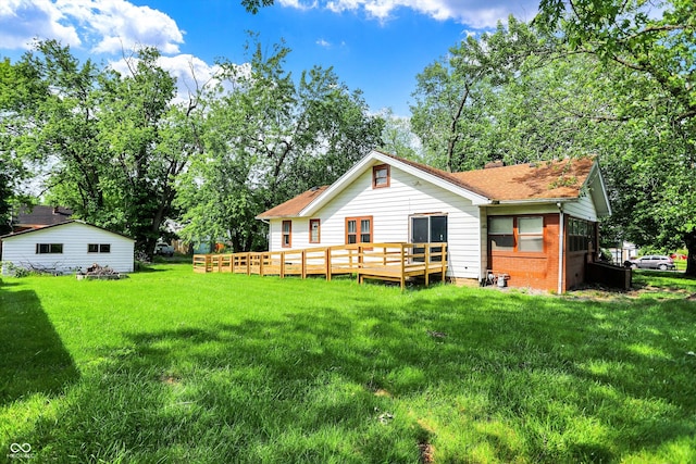 1523 E Mills Ave, Indianapolis, IN 46227 - back of house with a lawn, a deck, a chimney, a shingled roof, and view of wooded area