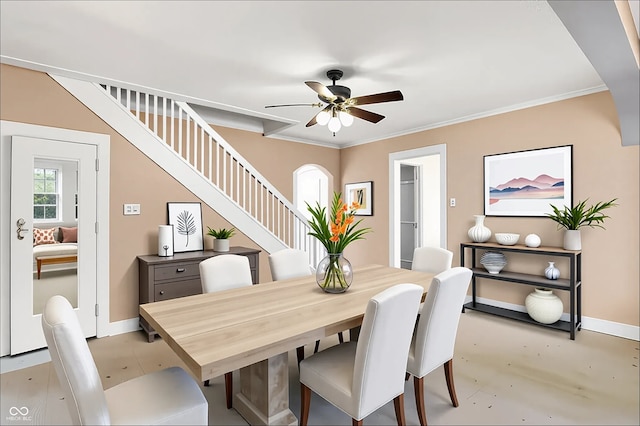 1523 E Mills Ave, Indianapolis, IN 46227 - dining area with stairs, a ceiling fan, crown molding, and arched walkways