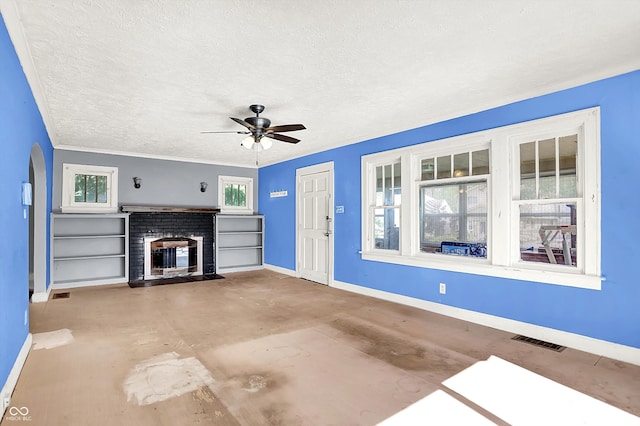 1523 E Mills Ave, Indianapolis, IN 46227 - unfurnished living room featuring a brick fireplace, a ceiling fan, a textured ceiling, arched walkways, and concrete flooring