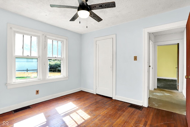 1523 E Mills Ave, Indianapolis, IN 46227 - unfurnished bedroom featuring dark wood finished floors, a textured ceiling, and ceiling fan