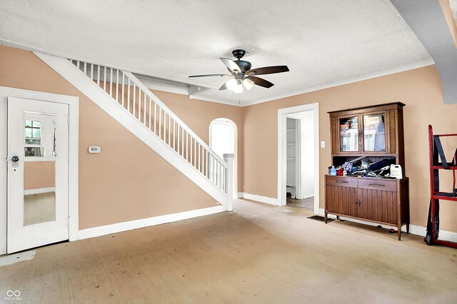 1523 E Mills Ave, Indianapolis, IN 46227 - spare room with stairway, plenty of natural light, a ceiling fan, arched walkways, and a textured ceiling