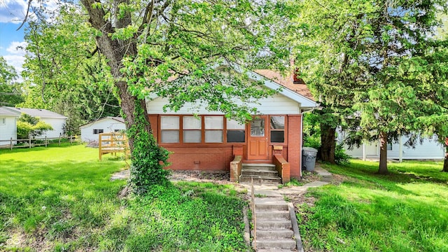 1523 E Mills Ave, Indianapolis, IN 46227 - view of front of home featuring brick siding, entry steps, and a chimney