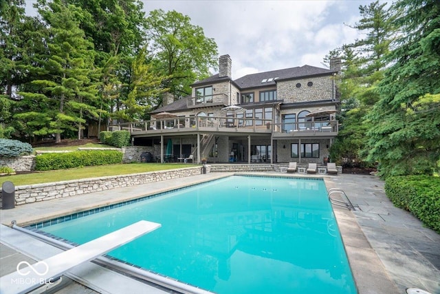11715 Landings Dr, Indianapolis, IN 46256 - outdoor pool with a wooden deck, a diving board, a patio, and stairs