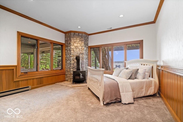 11715 Landings Dr, Indianapolis, IN 46256 - bedroom with a wood stove, ornamental molding, carpet flooring, wainscoting, and baseboard heating